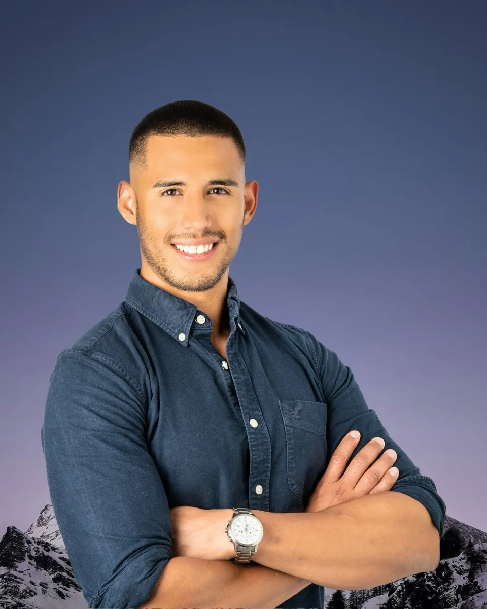 Bruno Serrano Trejo — professional headshot in navy blue shirt with arms crossed, smiling warmly against a black background
